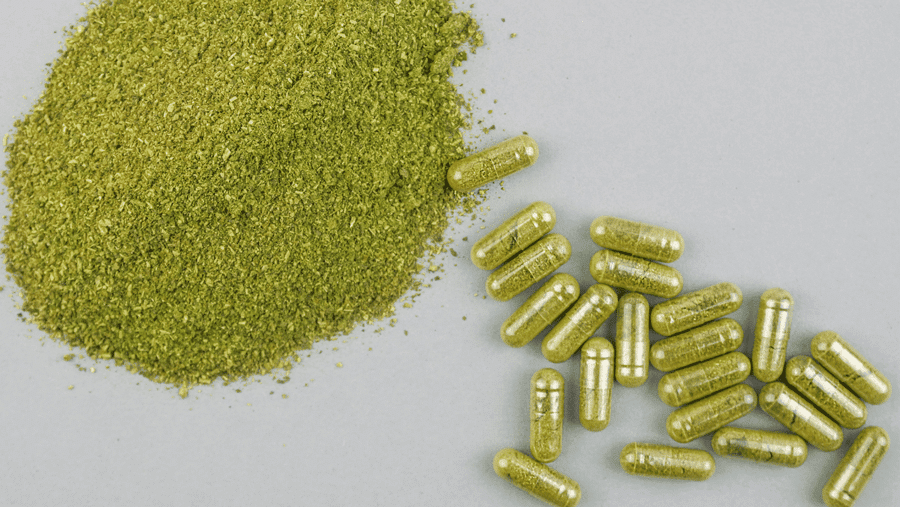 picture of green kratom capsules and powder